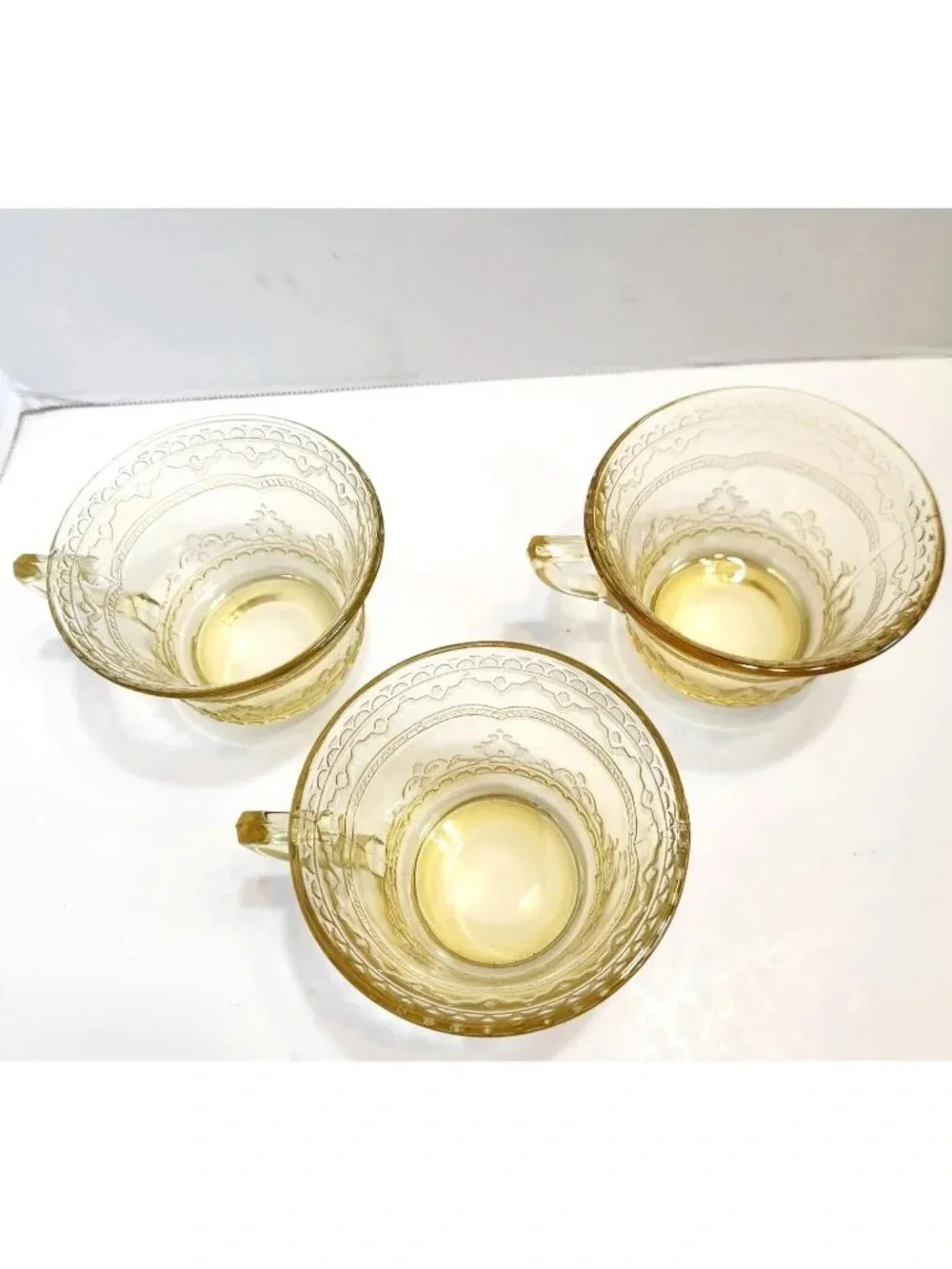 Elegant Amber Glass Teacup with Etched Decorative Pattern